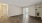 a room with a wood floor and a plant