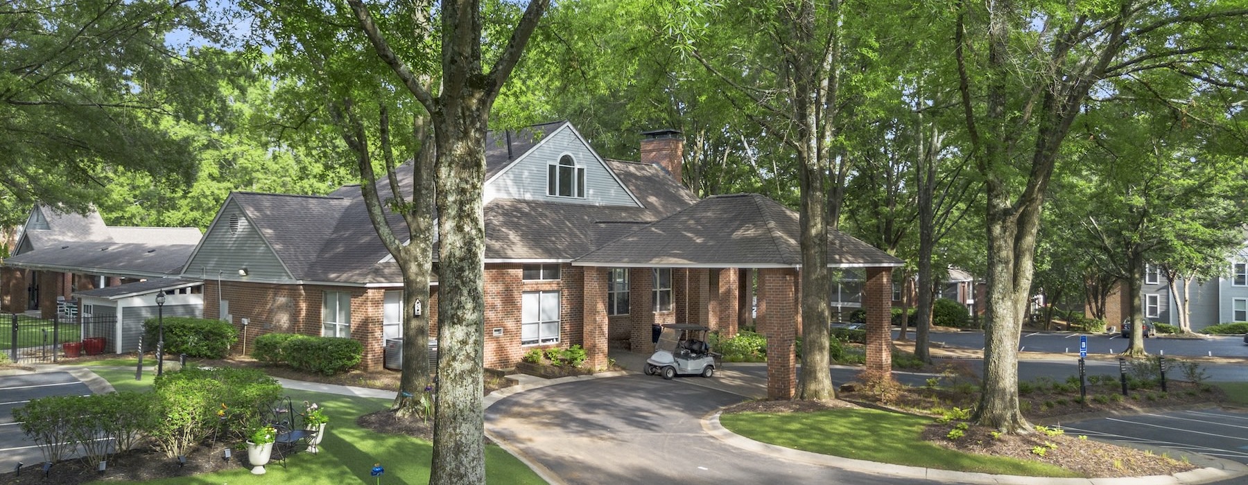 a house with a driveway and trees