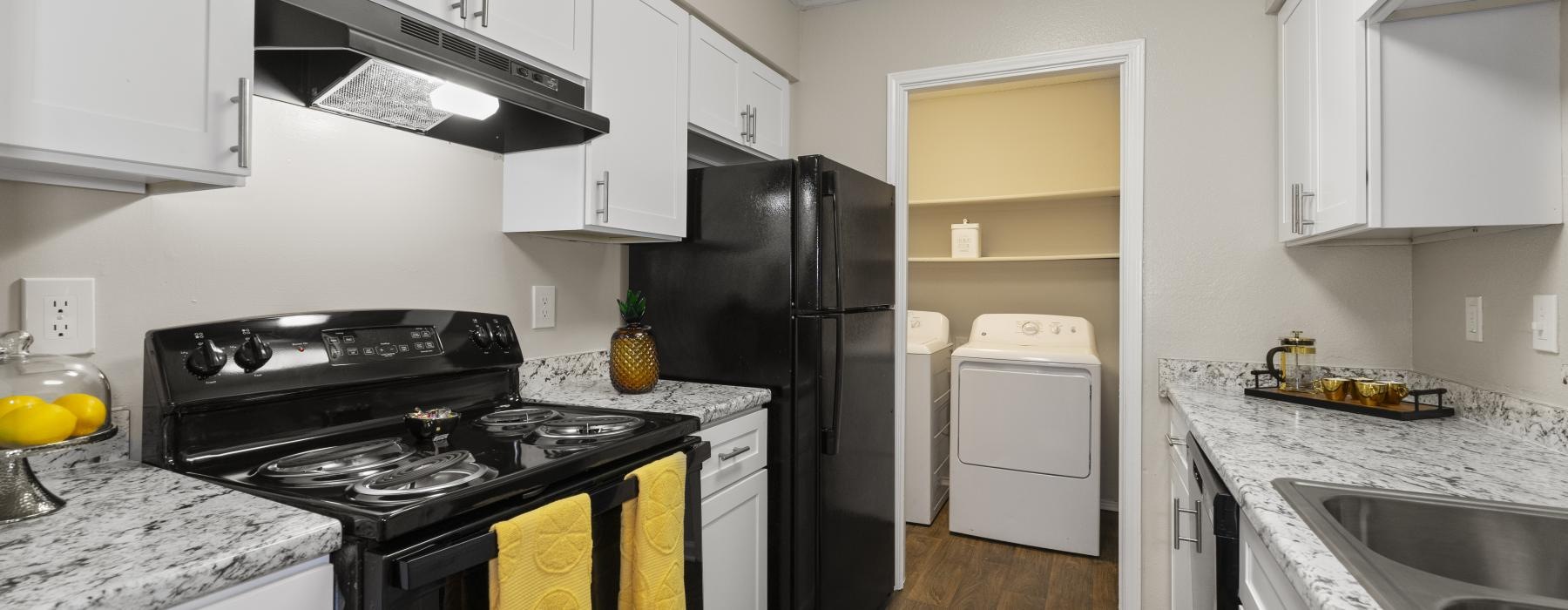 a kitchen with white cabinets