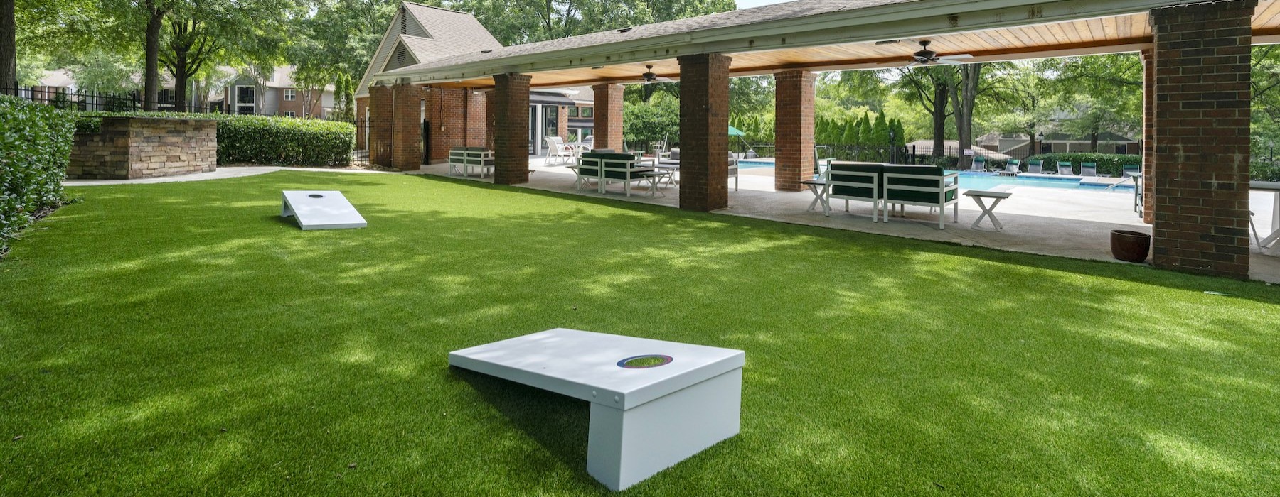 outdoor social area with cornhole game