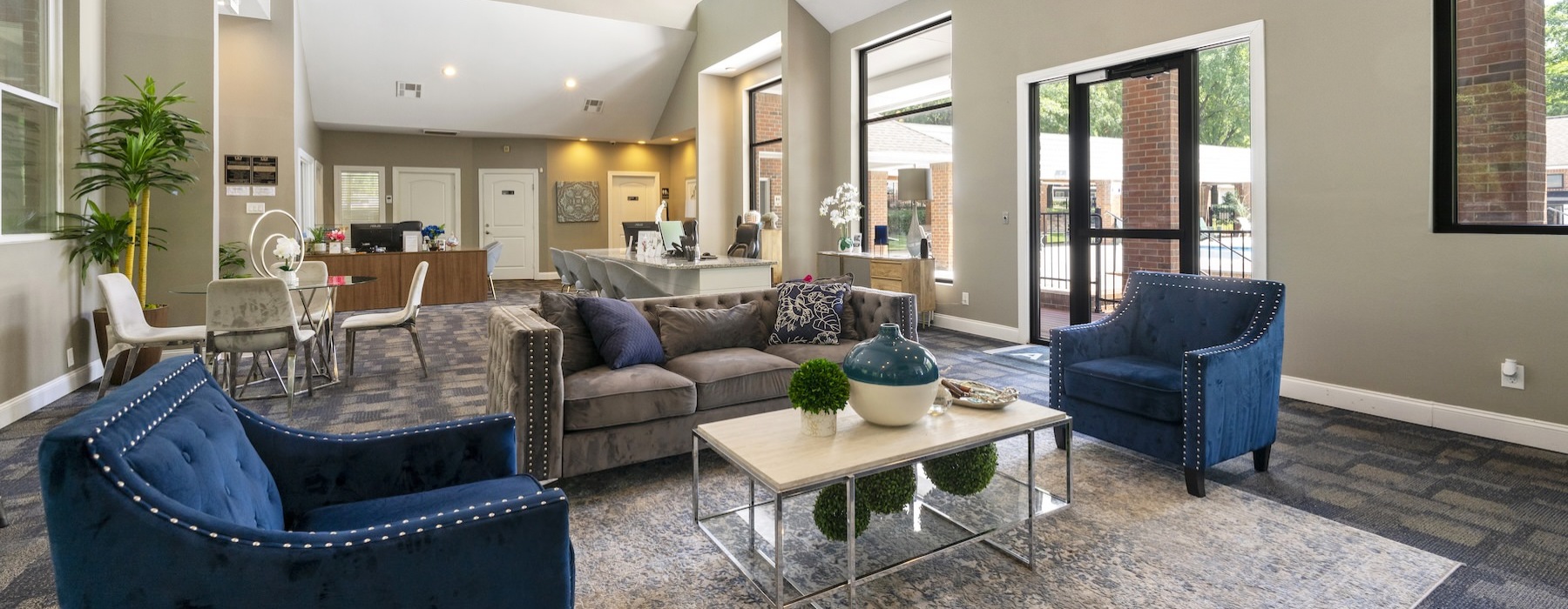 a club room with a couch and chairs