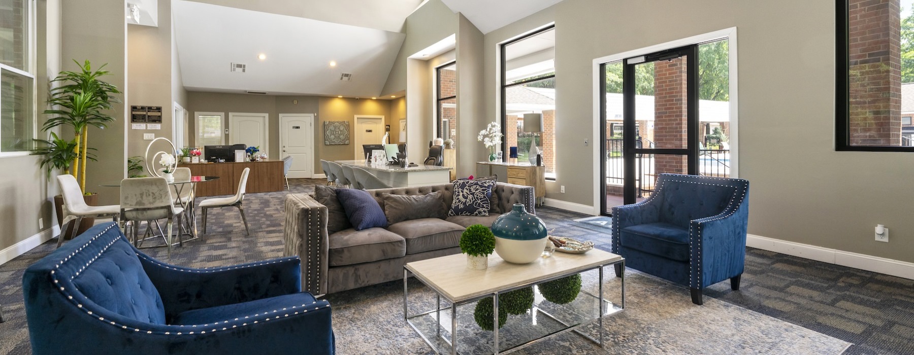 a club room with a couch and chairs