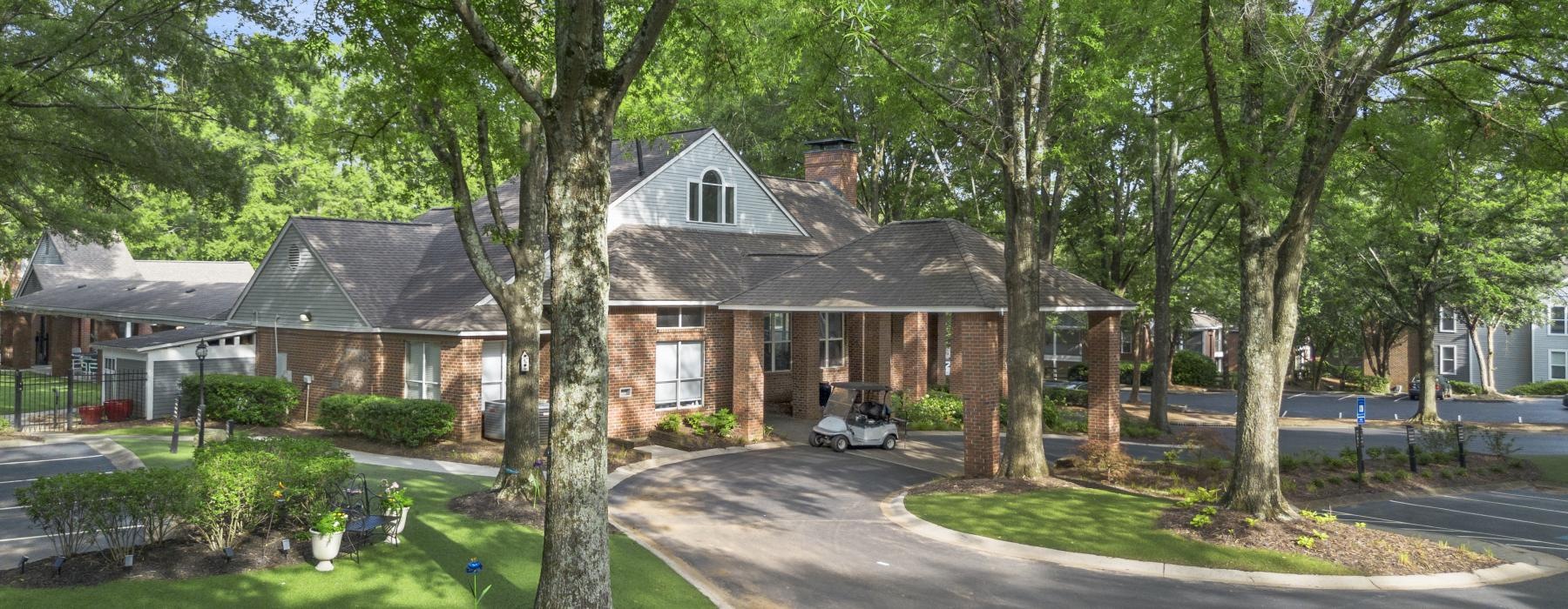 a house with a driveway and trees
