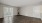 a room with a wood floor and a plant in it