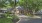 a house with a driveway and trees