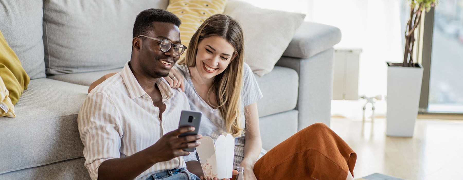 a man and woman sitting on the floor together